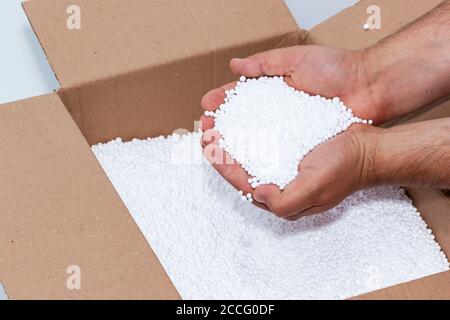 Round Styrofoam balls in my hands, the texture for the background. Environmental protection Stock Photo