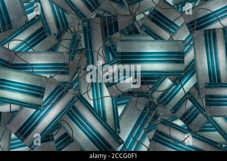Face mask background blue random pattern with ear loops. Medical waste concept.