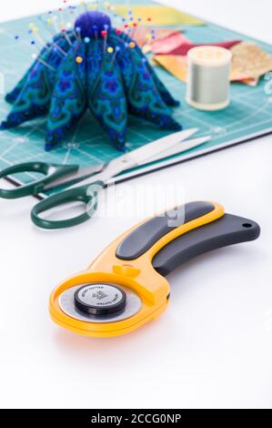 Rotary cutter on the white surface in the foreground Stock Photo