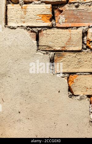 Half-finished plastered old brick wall Stock Photo