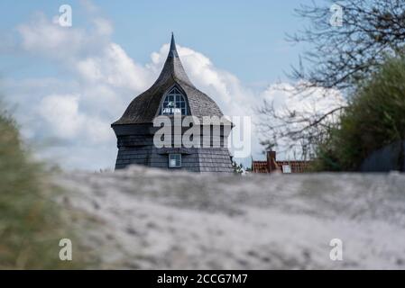 Germany, Mecklenburg-West Pomerania, Hiddensee, an old windmill stands behind the dike in the fishing village of Vitte. Stock Photo