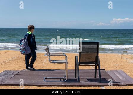 Boy, two chairs, Vitte beach, Hiddensee Stock Photo