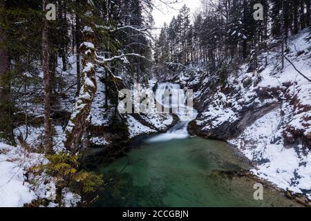 Waterfall of the Obernach Canal between Wallgau and the Walchensee in the Bavarian Prealps in winter with snow Stock Photo
