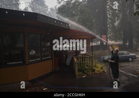 Boulder Creek, United States. 22nd Aug, 2020. Allen Strong waters down the roof of a friends restaurant in Ben Lomond, California as the CZU Lightning Complex fire continues to burn well into its fourth day with more than 50,000 acres torched, more than 100 structures destroyed and more than 75,000 people evacuated across two counties on Friday, August 21, 2020. Photo by Peter DaSilva/UPI. Credit: UPI/Alamy Live News Stock Photo