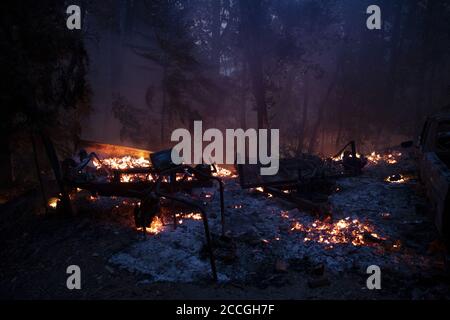 Boulder Creek, United States. 22nd Aug, 2020. The remains of a burnt home smolder in to the night in Boulder Creek, California as the CZU Lightning Complex fire continues to burn well into its fourth day with more than 50,000 acres torched, more than 100 structures destroyed and more than 75,000 people evacuated across two counties on Friday, August 21, 2020. Photo by Peter DaSilva/UPI Credit: UPI/Alamy Live News Stock Photo