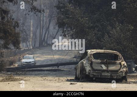 Boulder Creek, United States. 22nd Aug, 2020. The remains of a burnt vehicle and toppled power pole in Boulder Creek, California as the CZU Lightning Complex fire continues to burn into its fourth day with more than 50,000 acres torched, more than 100 structures destroyed and more than 75,000 people evacuated across two counties on Friday, August 21, 2020. Photo by Peter DaSilva/UPI Credit: UPI/Alamy Live News Stock Photo