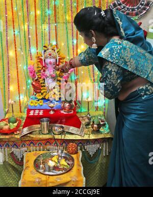 Beawar, Rajasthan, India, Aug 22, 2020: An Indian woman offer prayers to Lord Ganesha (Elephant-Headed Hindu Deity) at her home on the occasion of Ganesh Chaturthi festival amid COVID-19, in Beawar. Credit: Sumit Saraswat/Alamy Live News Stock Photo