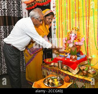 Beawar, Rajasthan, India, Aug 22, 2020: A couple offer prayers to Lord Ganesha (Elephant-Headed Hindu Deity) at their home on the occasion of Ganesh Chaturthi festival amid COVID-19, in Beawar. Credit: Sumit Saraswat/Alamy Live News Stock Photo