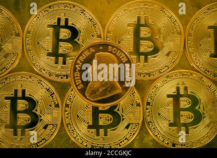 physical gold coin 1 oz gold Krugerrand obverse Paul Kruger on Bitcoin coins, symbolic image gold versus cryptocurrency Stock Photo