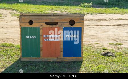 Containers for separate waste collection. wooden waste box on the street.  Stock Photo