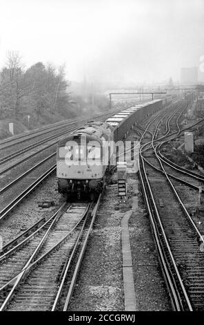 A pair of Class 33 diesel locomotives numbers 33063 and 33012 working a train loaded with concrete segments for lining the channel tunnel at Grove Park on the 3rd December 1990.