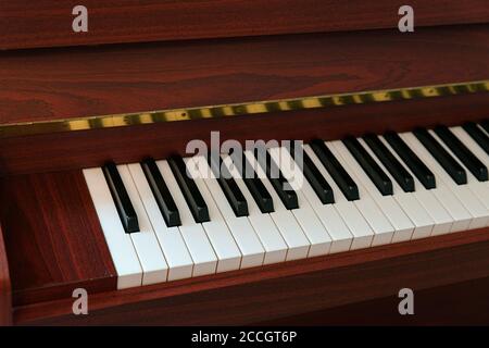 close up of piano keys, ivory and ebony  keys on a rosewood modern piano Stock Photo