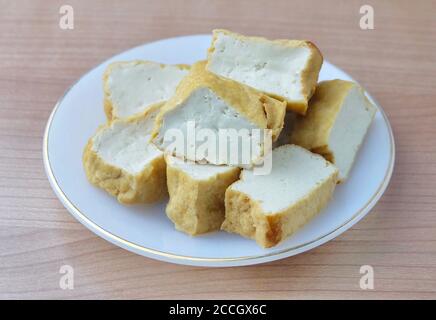 Cuisine and Food, Chinese Deep Fried Tofu or Fried Bean Curd Usually Served with Sweet and Sour Spicy Sauce. High in Vitamin B9, B1, B2 and K. Stock Photo