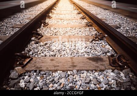 Transportation industry concept background: Railroad in motion with sunset light. Railway station with motion blur effect . Railroad travel, railway Stock Photo