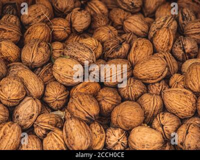 Natural walnut background pattern texture Abstract walnuts heap pattern background. Stock Photo