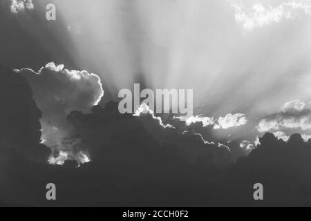 landscape sky with rays of the sun making their way through thunderclouds, black and white photo Stock Photo