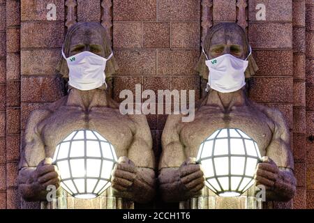 Helsinki, Finland - August 16, 2020: The 'Lantern Carriers' at Helsinki Central Railway Station was adorned with face masks during the COVID-19 pandem Stock Photo