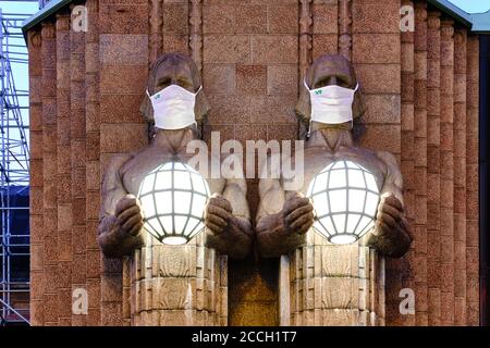 Helsinki, Finland - August 16, 2020: The 'Lantern Carriers' at Helsinki Central Railway Station was adorned with face masks during the COVID-19 pandem Stock Photo