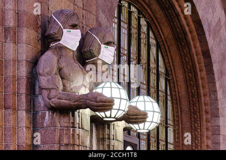 Helsinki, Finland - August 16, 2020: The 'Lantern Carriers' at Helsinki Central Railway Station was adorned with face masks during the COVID-19 pandem Stock Photo