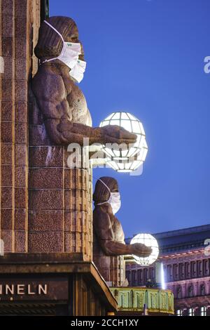 Helsinki, Finland - August 16, 2020: The 'Lantern Carriers' at Helsinki Central Railway Station was adorned with face masks during the COVID-19 pandem Stock Photo