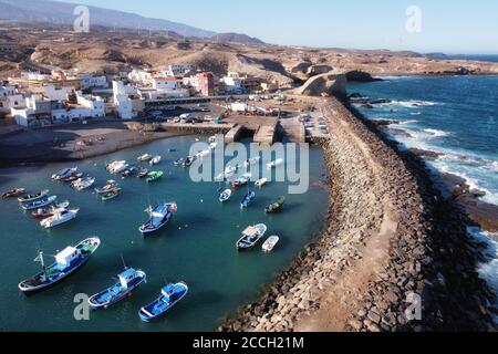 Aerial view of a little fishing town with some colorful boats in Tajao, Tenerife, Canary Islands. High quality photo