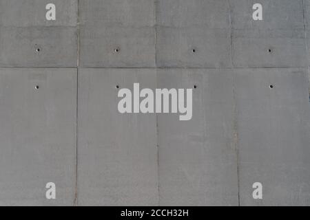 Straight-on view of solid smooth textured surface with horizontal and vertical lines and dot marks towards the top Stock Photo