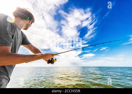 Fly fisherman throwing fishing reel in river to catch fish during sunset  Stock Photo - Alamy