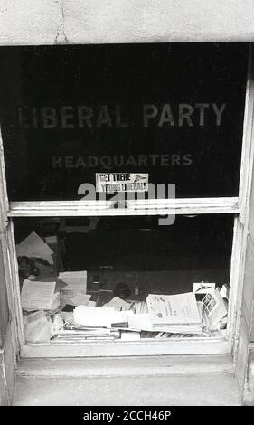 1960s, historical, Exterior view down to a sash window of the Liberal Party headquarters, Victoria, London, England, UK, with Party name stenciled into the glass and a sticker for the 'Young Liberals'. In the 19th and 20th centuries, the Liberal Party was one of the two major political parties in the UK, arising from a alliance of Whigs, free trade Peelites and Radicals. Stock Photo