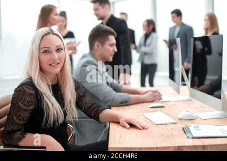 smiling young woman at the workplace, in the office Stock Photo