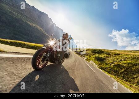 Motorcycle driver riding in Alpine highway,  Hochalpenstrasse, Austria, Europe. Outdoor photography, mountain landscape. Travel and sport photography. Stock Photo