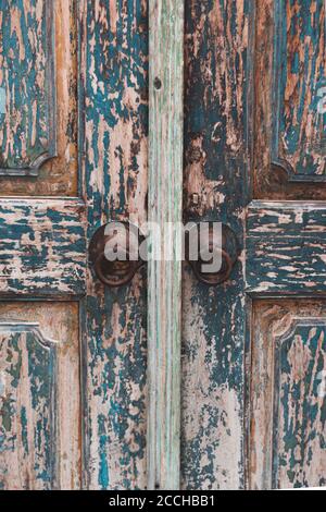 Vintage wooden door painted with antique copper knobs. Stock Photo