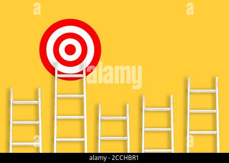 White stairs on an yellow background and a target. Striving for goals, success and achievements. Career ladder. The concept of leadership in business Stock Photo