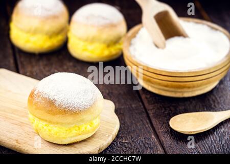 "Sonho", sweet bread stuffed with cream, made with eggs, baumilia, sugar, milk and yeast. It is typical of Brazil, Portugal and Germany. Stock Photo
