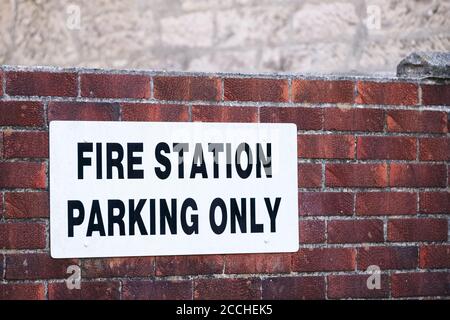 Fire station parking only on wall car park sign Stock Photo