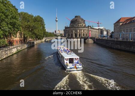 River Cruise on the Spree River in Berlin, approaches the Bode Museum  on Museumsinsel. The Fernsehturm is visible in the background Stock Photo