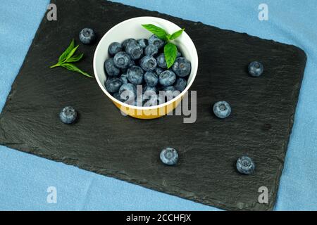 Selection of fruit strawberries blueberries and raspberries on a food plater and bowl showing healthy food choices Stock Photo