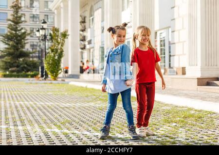 Portrait of happy fashion little girls having fun in the city Stock Photo