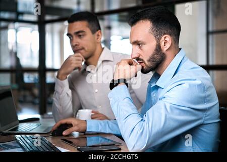 Two adult businessman working together in office Stock Photo