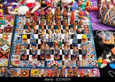 The traditional chess game art and craft product with Spanish against Inca people on a local handicraft market in Pisac, near Cusco, Peru Stock Photo