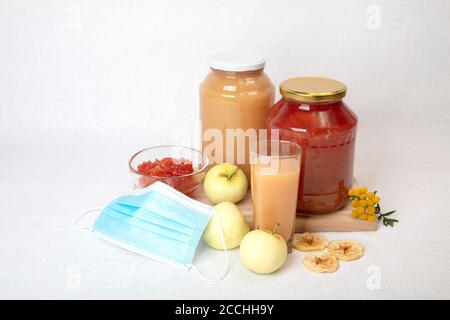 Apple jam and juice, fresh and dried apples, medical mask, still life, homemade concept and natural food will strengthen the immune system during the coronavirus. High quality photo Stock Photo