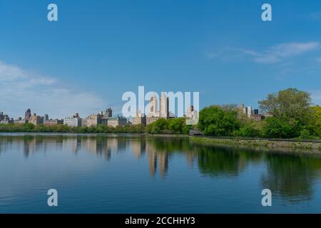 Central Park West Residences reflect to the Central Park Reservoir Stock Photo