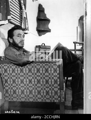 HUMPHREY BOGART in costume as Fred C. Dobbs relaxes in dressing room during break in filming THE TREASURE OF THE SIERRA MADRE 1948 director / screenplay JOHN HUSTON novel B. Traven Warner HUMPHREY BOGART in costume as Fred C. Dobbs relaxes in dressing room during break in filming THE TREASURE OF THE SIERRA MADRE 1948 director / screenplay JOHN HUSTON novel B. Traven Warner