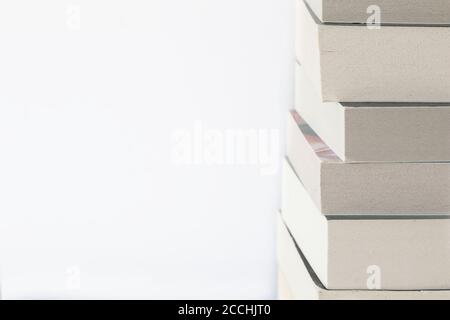 Stacked up books on white background with lot of copy space Stock Photo
