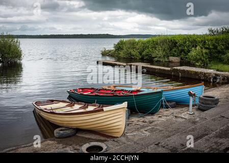 Wooden rowboats in a small marina on lake Melvin in County Leitrim Ireland Stock Photo