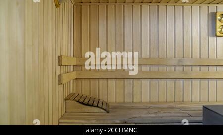 Sauna accessories are in the interior of the steam room. The interior of the sauna. Sauna from linden. Stock Photo