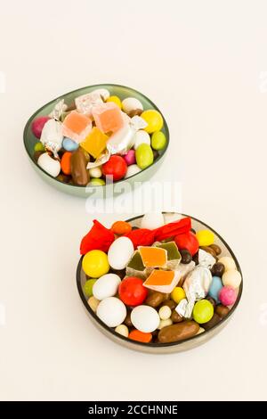 Traditional Turkish Colorful candy and delight on white with coffee. Stock Photo