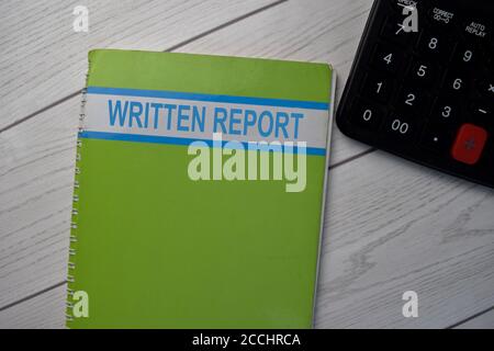 Book about Written Report isolated on wooden table. Stock Photo