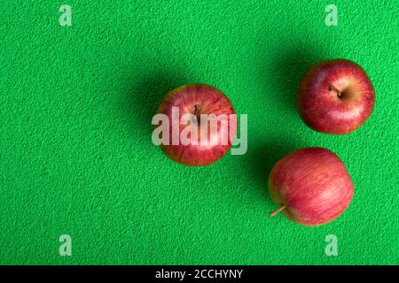 ripe red apples on a green background.selective focus Stock Photo