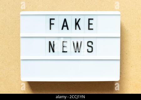 Lightbox with word fake news on wood background Stock Photo