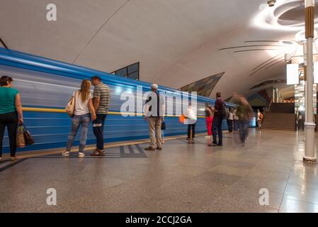 Kiev / Ukraine - June 1, 2019: people in Kiev subway with blue train in beautiful station Stock Photo